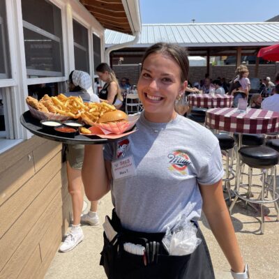 Waitress serving Saz's fair food
