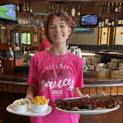 Waitress with full rack of ribs and mac n cheese
